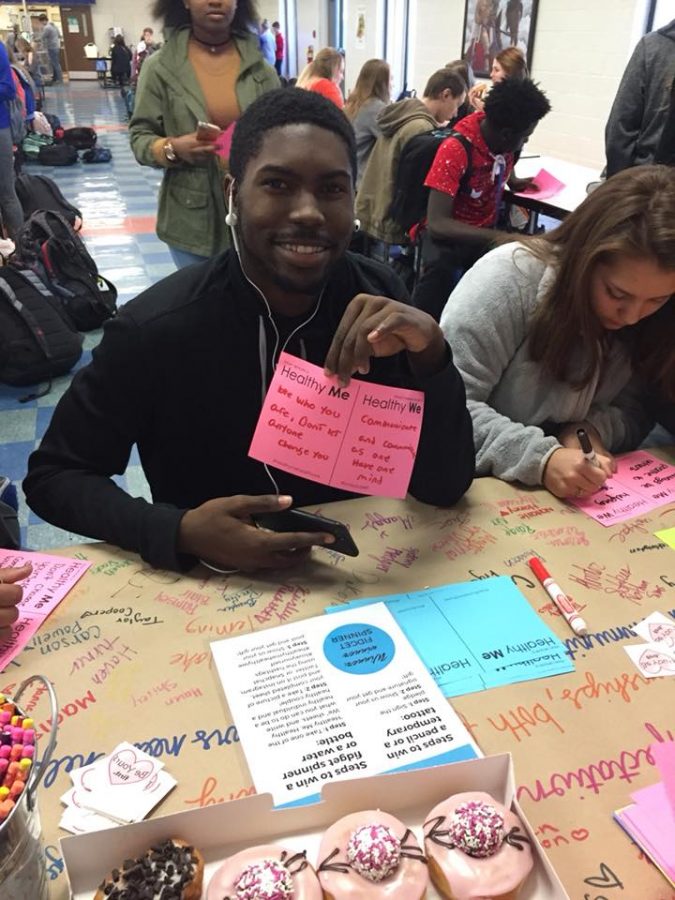 Senior, Tmac Lovelace posing with his filled out “Healthy Me, Healthy We” paper. 