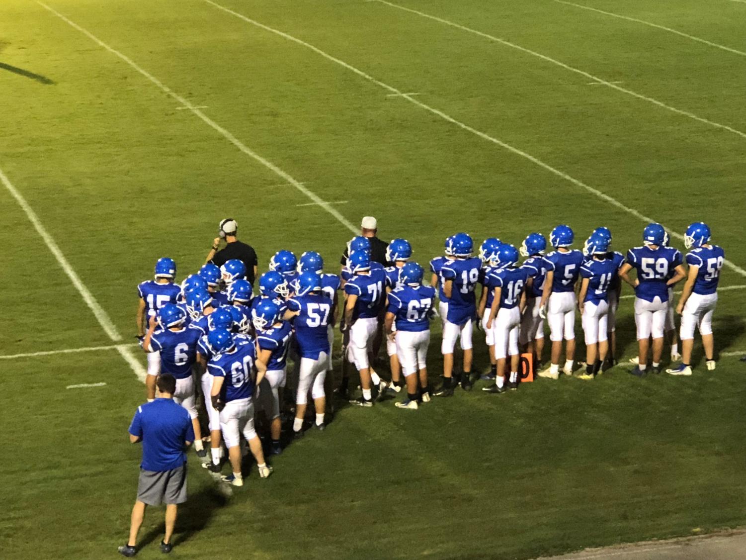 The football team watches from the sidelines as their teammates are playing in the scrimmage game held Friday August 10 against the Southeast Whitfield.