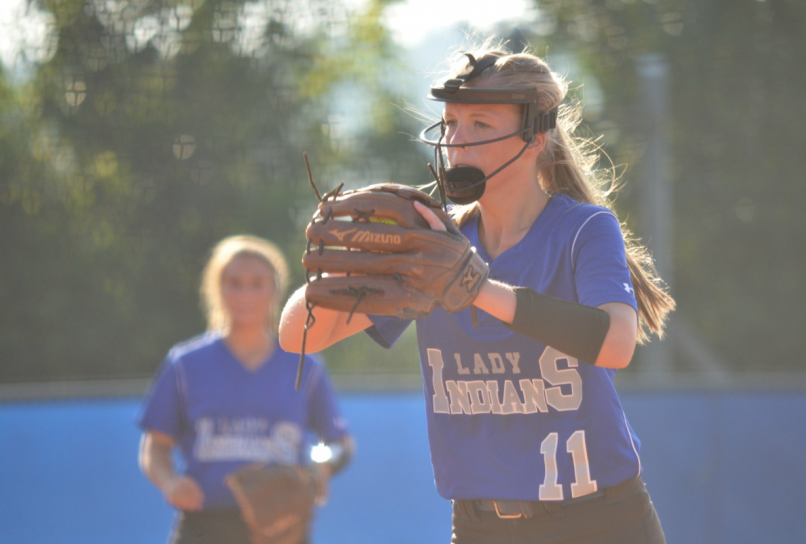 Senior Harlie Lewis begins her pitch after she gets the pitch from head Coach Shane Arp against Model.