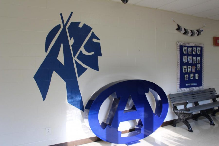 	Outside the office sits the 2018 class bench, but that isnt the only new thing in that spot. Painted on the wall is an A in the shape of a teepee and an Indian head. Next to it sits a decoration of the Armuchee A logo. 