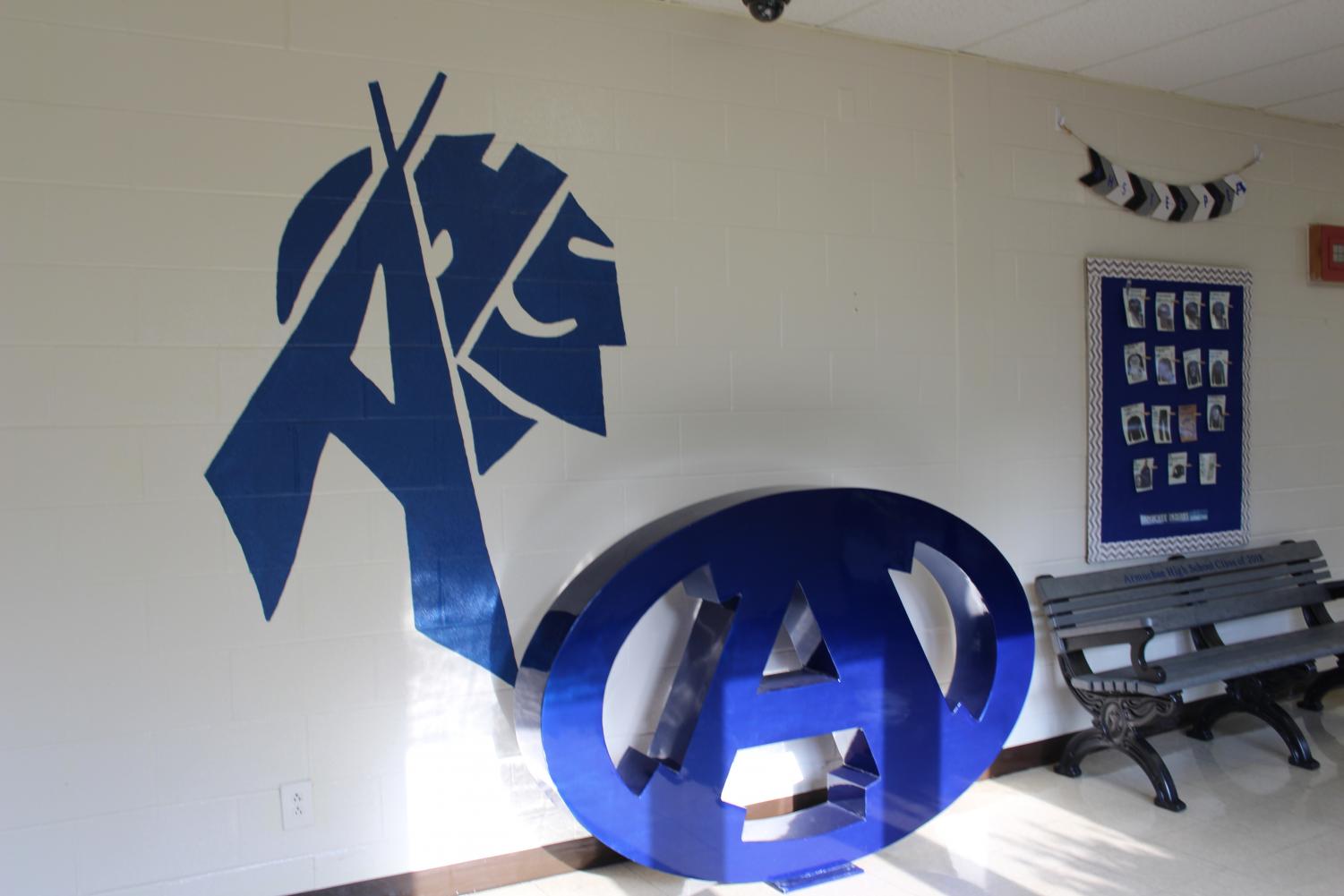 Outside the office sits the 2018 class bench, but that isn't the only new thing in that spot. Painted on the wall is an A in the shape of a teepee and an Indian head. Next to it sits a decoration of the Armuchee A logo.