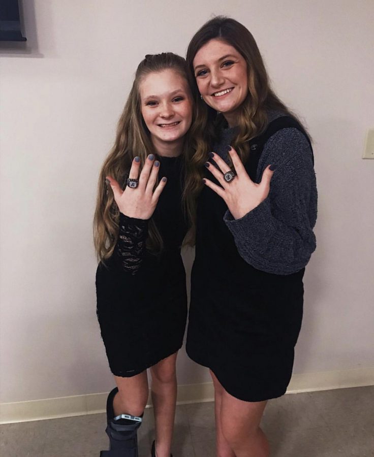 Annie Conley, freshman, and Logan Lively, sophomore, show off their bling they received on February 7, 2019. Lively said, When I first saw my ring, I was just so happy that the wait was finally over. I loved looking around at my teem mates faces and being reminded of when we won. Looking at my ring from this year and then at the one from last year really shows how time has flown by.
