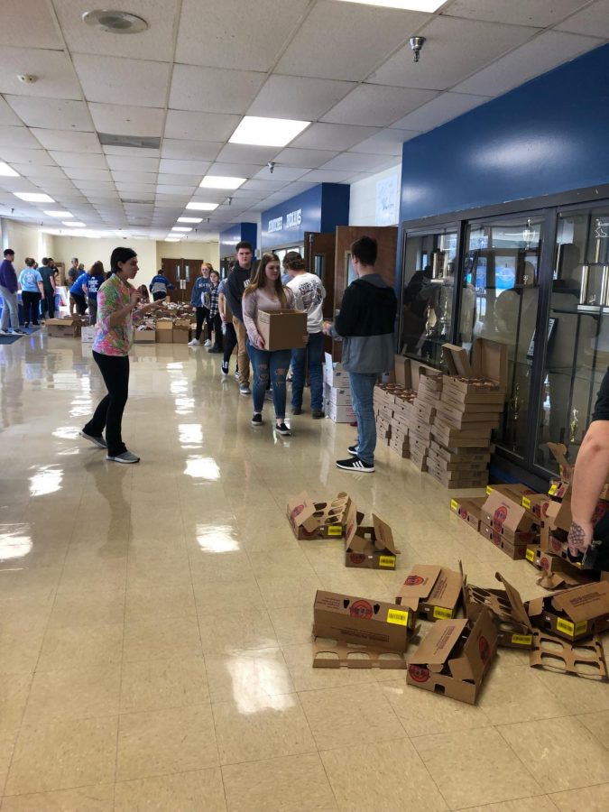 At the pop up market held on Wednesday, March 13th many NHS and Key Club members volunteered their time to help the people in need. Students helped stuff the boxes then helped the people carrying them to the cars. 