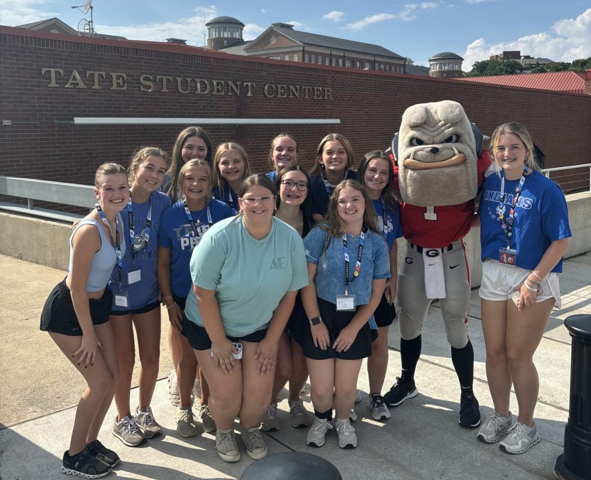 The Staff poses for a picture with the UGA mascot, Hairy Dawg.