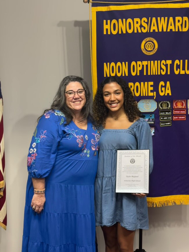 Taylor Ragland holding her Noon Optimist award alongside Mrs. Mowery