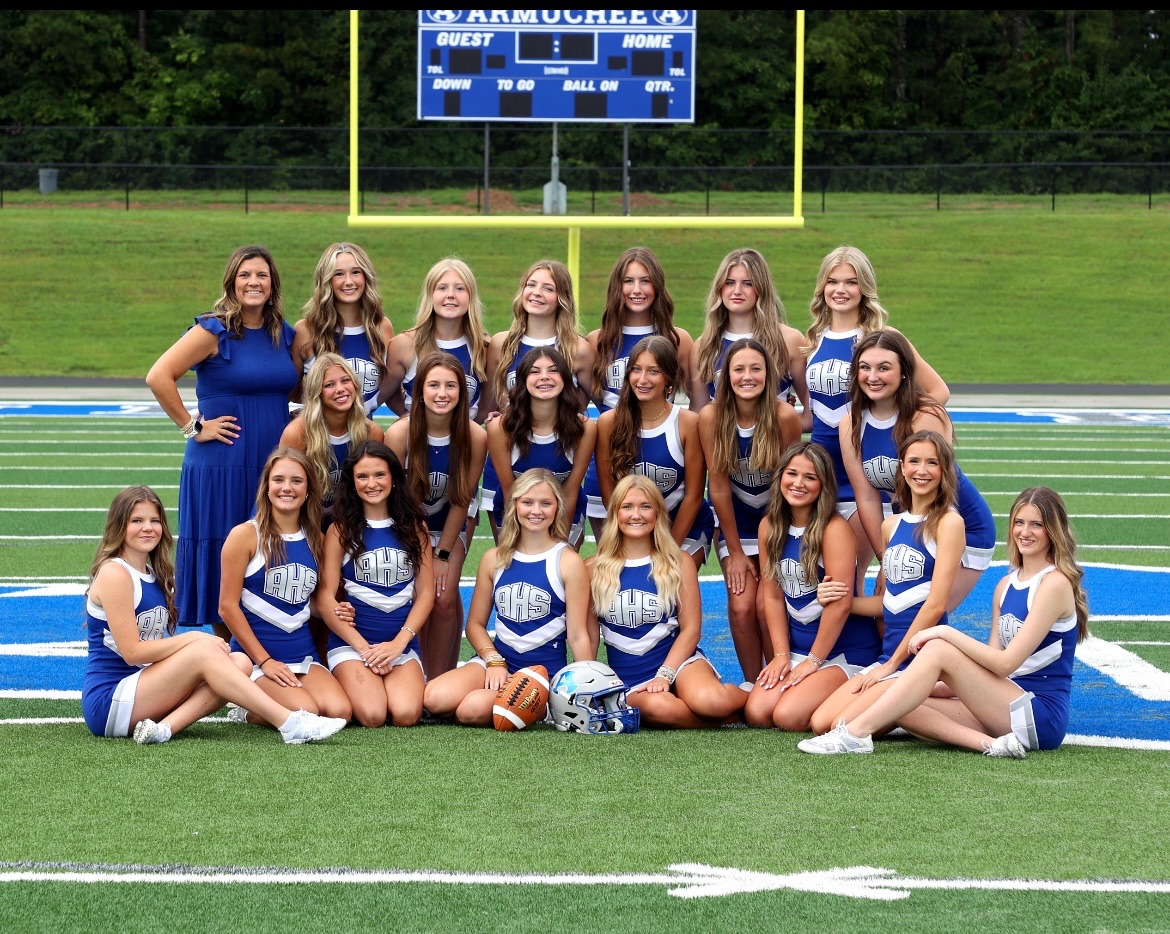 All of the 2024 Football Cheerleaders in a team picture with Coach Hellriegal 