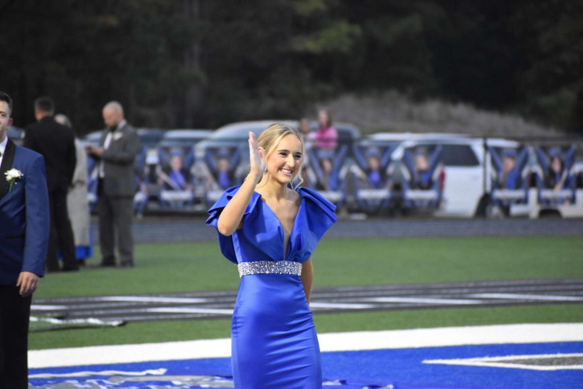 Taylor Burns waving to everyone in the bleachers.