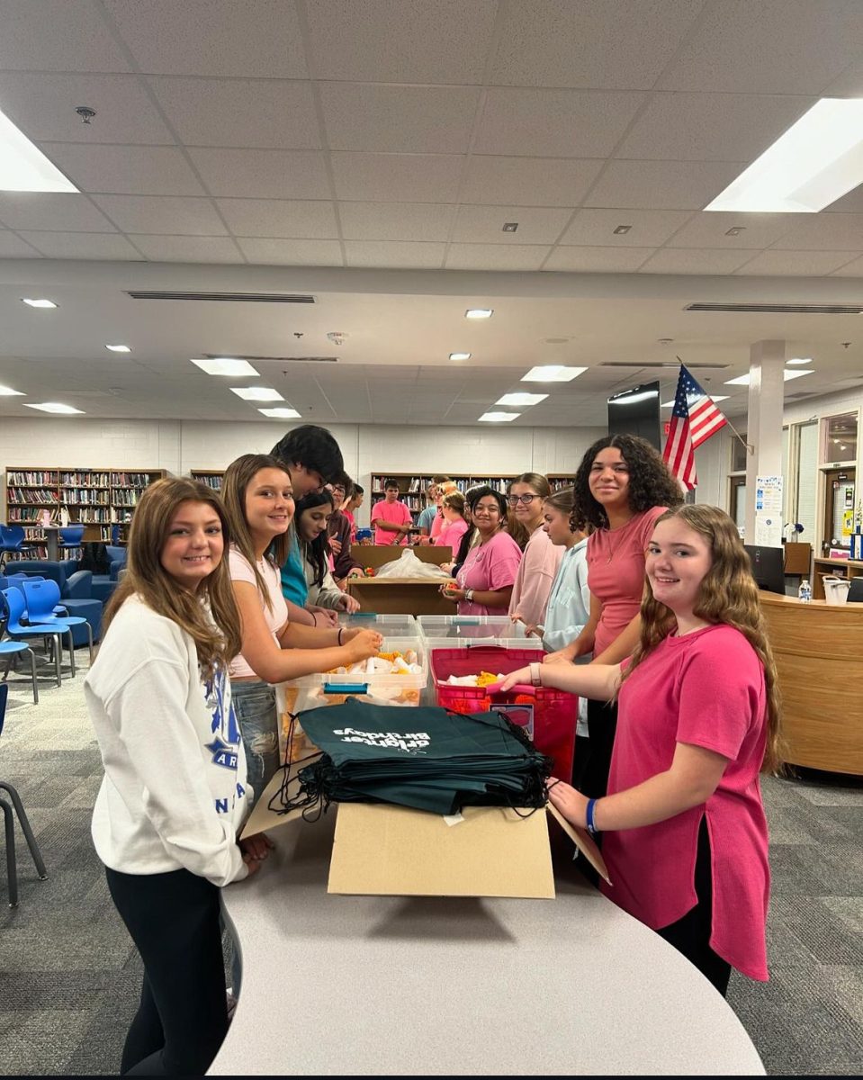 Key Club members gather to package goods for people in need.