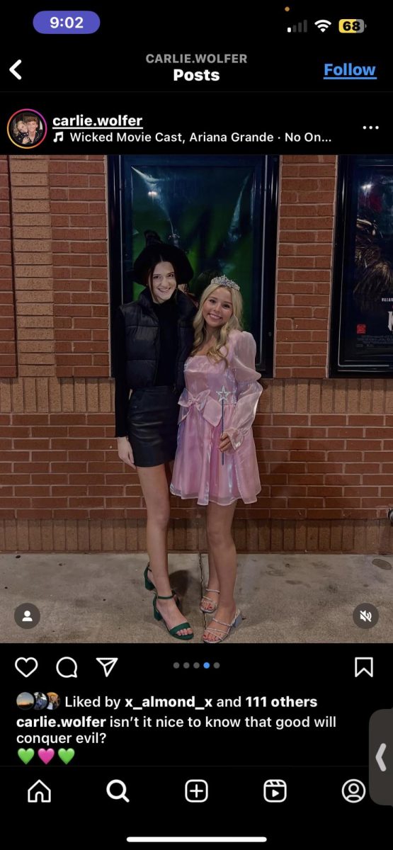 Carlie Wolfer and Abby Carson dressed as Elphaba and Glinda ready to watch the Wicked movie