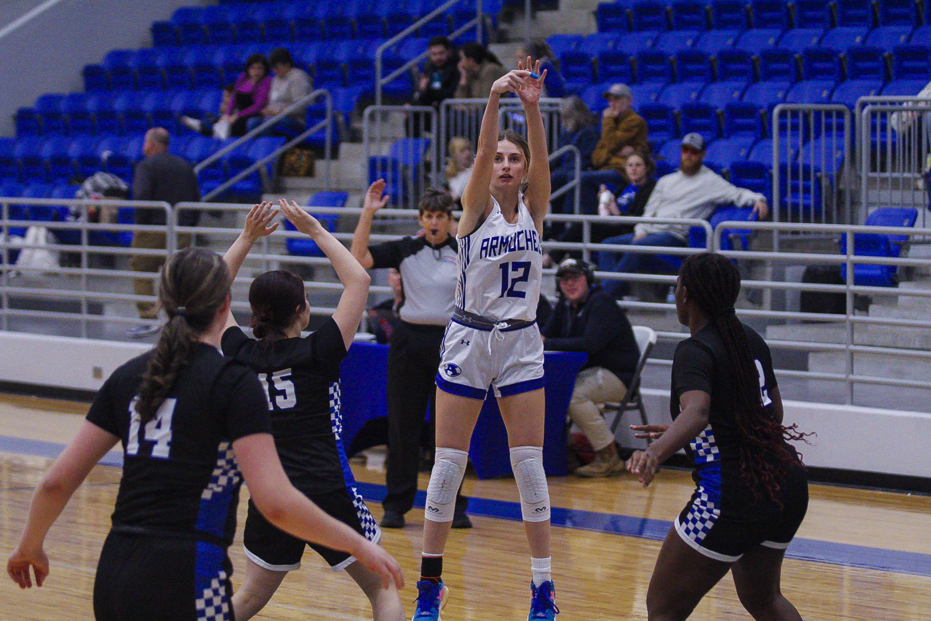 Sophie shooting a 3-pointer during a game. 