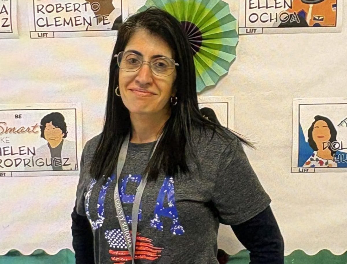 Dr. O standing next to her decorated bulletin board.